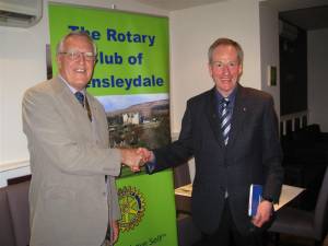 Michael Hepper being congratulated by President John Ogbourne